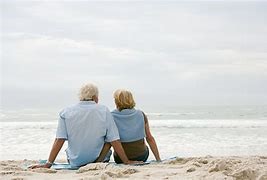 elderly-couple-sitting-beach.jpg