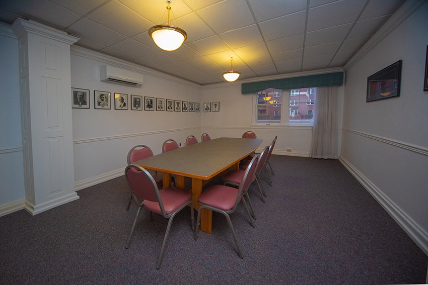 Inside of the CWU Munson Board Room, which features a large conference table with ten chairs.