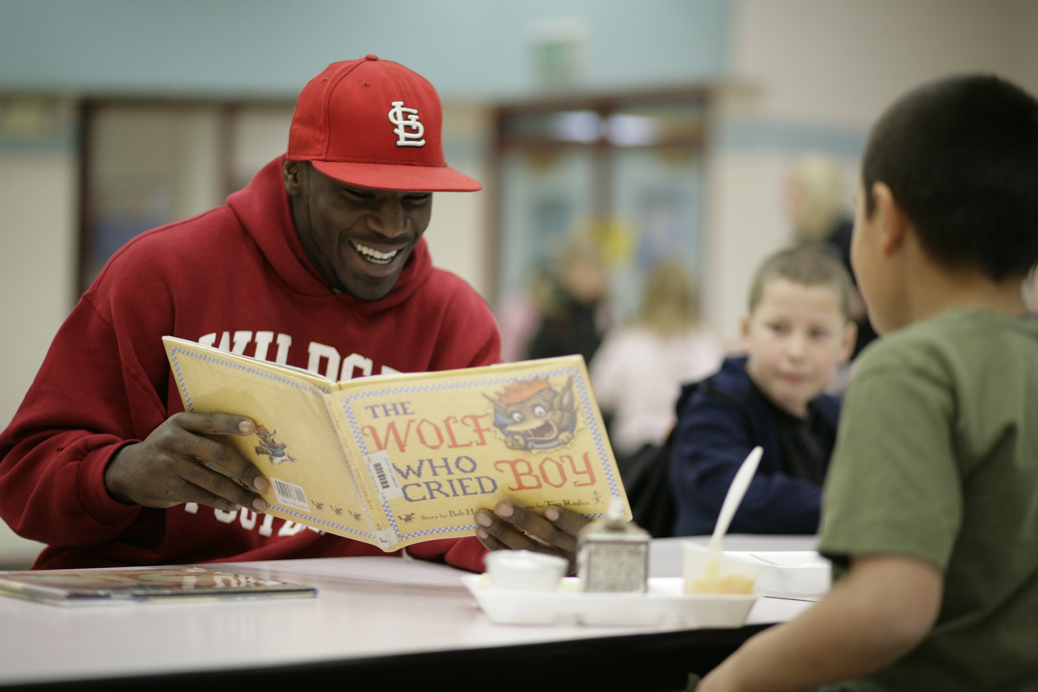 CWU student reads a book to children