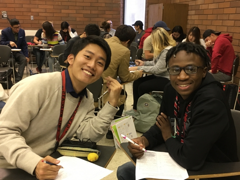 Two students smiling at the camera