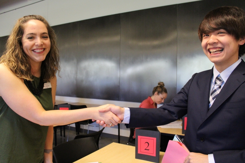 Two students shaking hands
