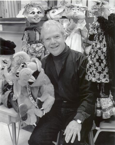 Image of James A. Hawkins. He is holding a puppet.