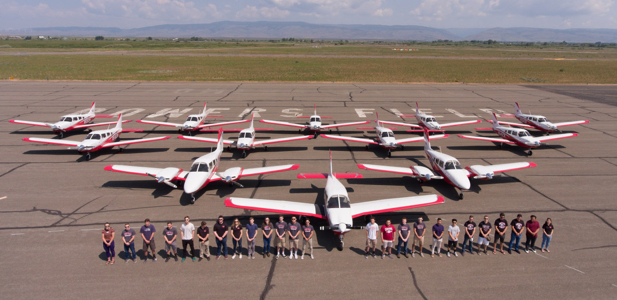 students, faculty, and staff standing in front of the cwu fleet