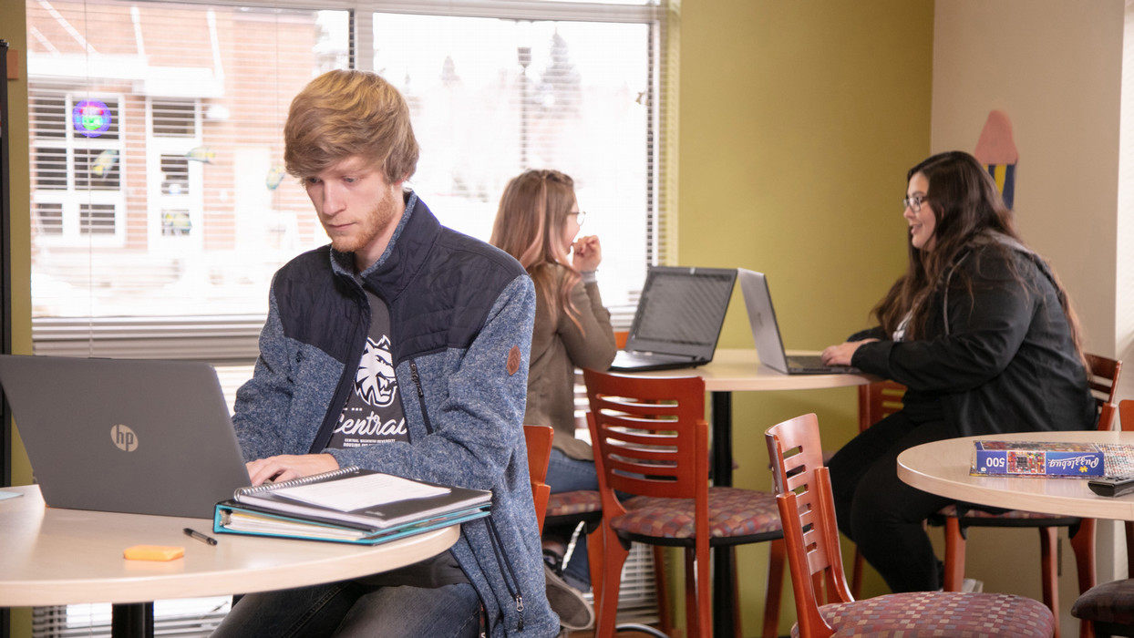 Three students study hard and attentively within the career program at Central Washington University.