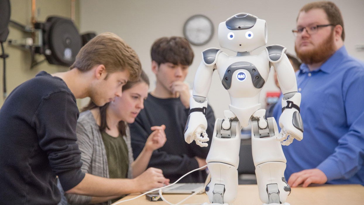 Students within the computer science program at Central Washington University work with a NAO Robot.