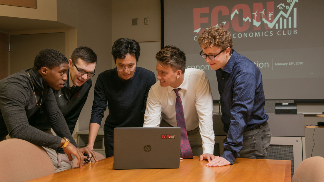 Five students engage in conversation within the economics department within Central Washington University.