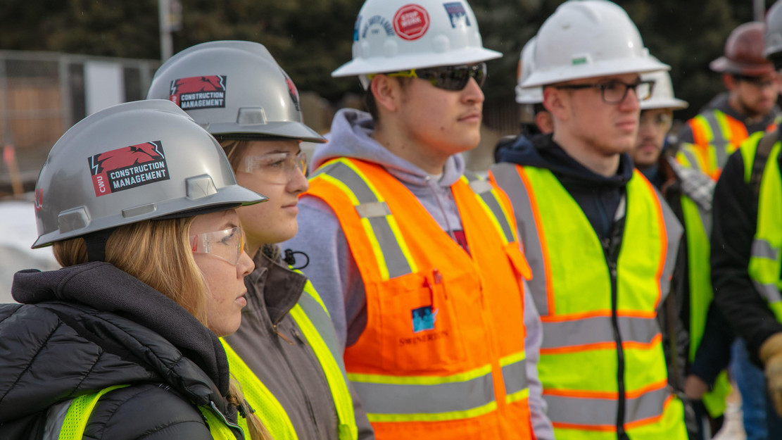 Students wear protective gear as they work on a construction site in Ellensburg.