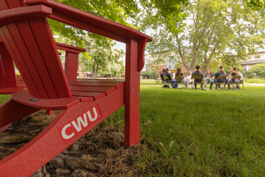 Up close shot of a red lawn chair with the CWU logo on it.