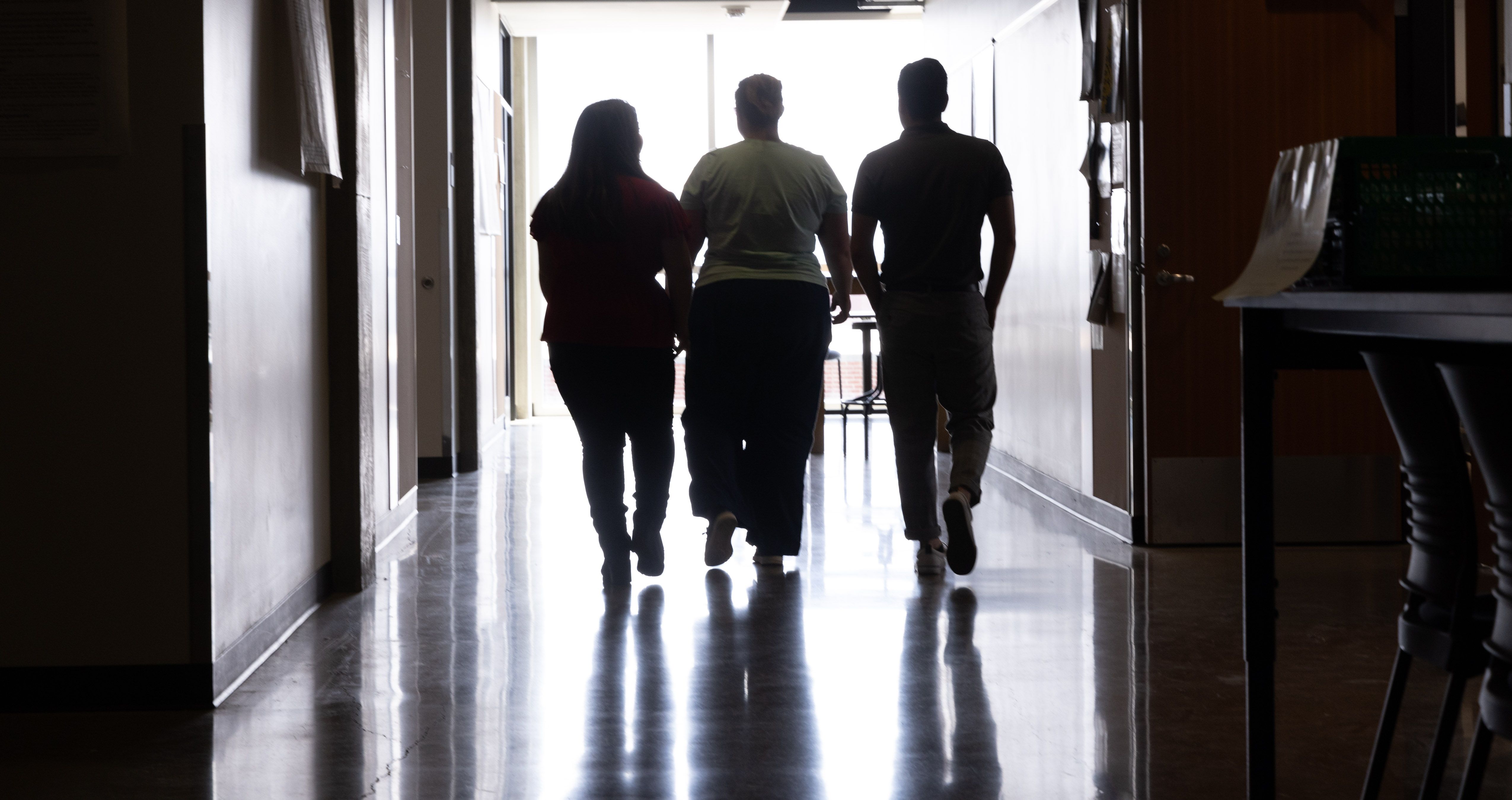 Three students within the sociology department at Central Washington University take a walk through the halls.