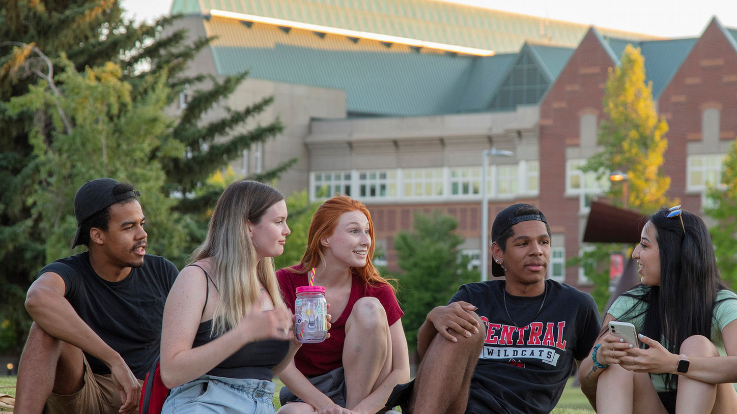 Five students at central washington university engaging in conversation outside