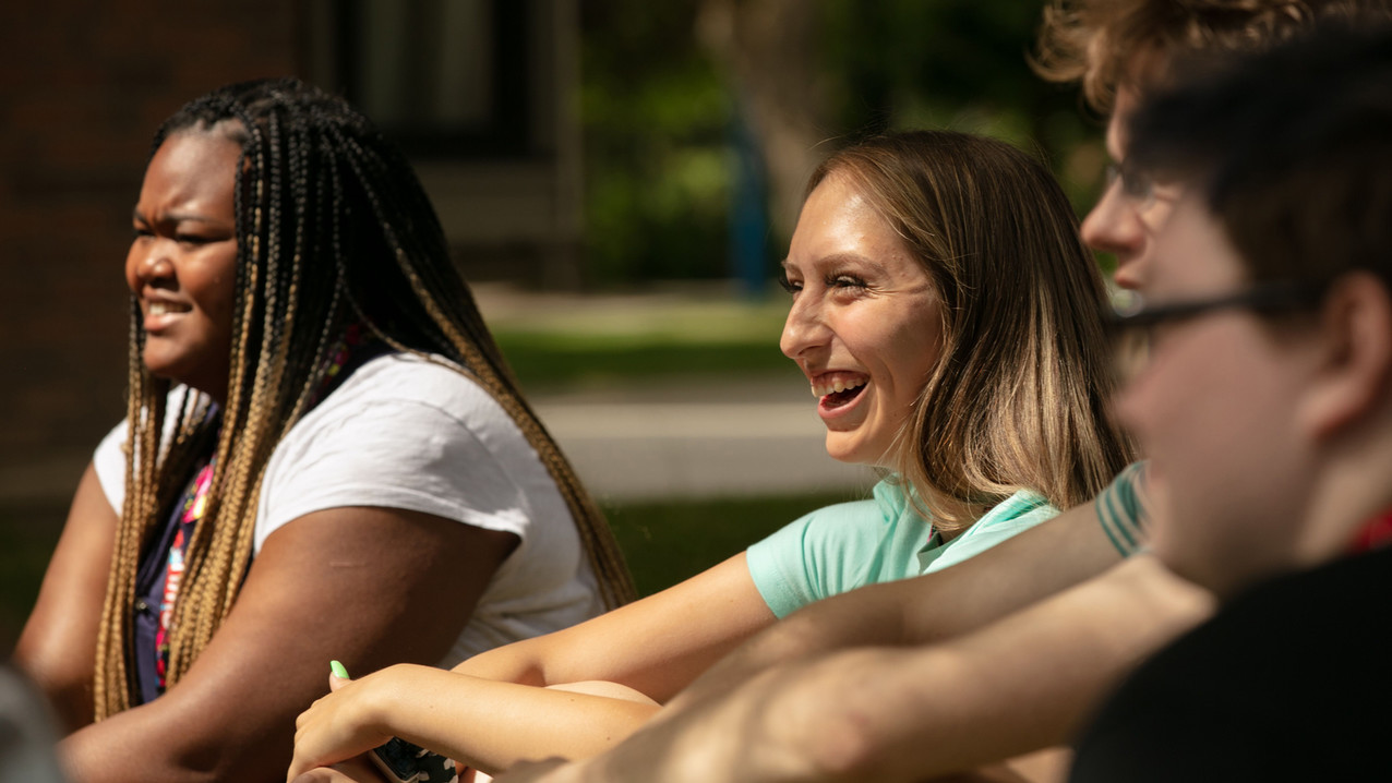 Four students at Central Washington University take a seat and share a laugh.