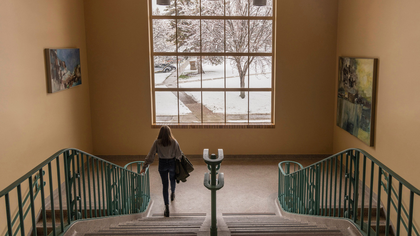 A woman takes a walk down the stairs within Central Washington University.