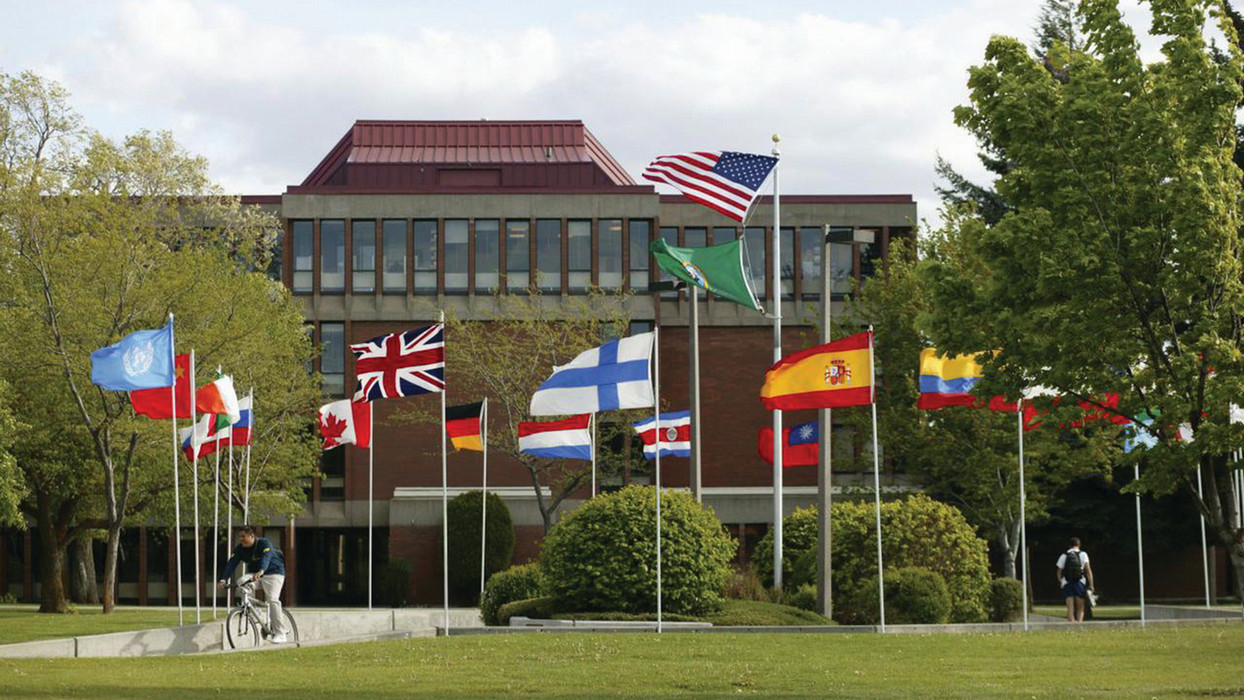 An assortment of flags are displayed outside of the world languages department at Central Washington University.