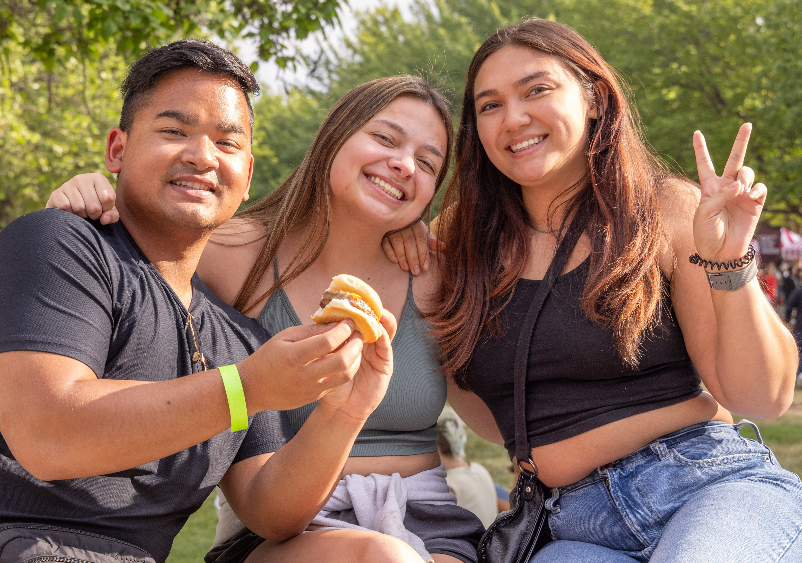 Three students enjoying hamburgers