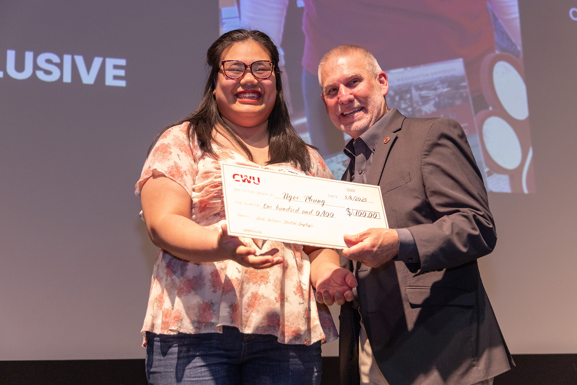 Student Ngoc Phung accepts her award check from President Wohlpart