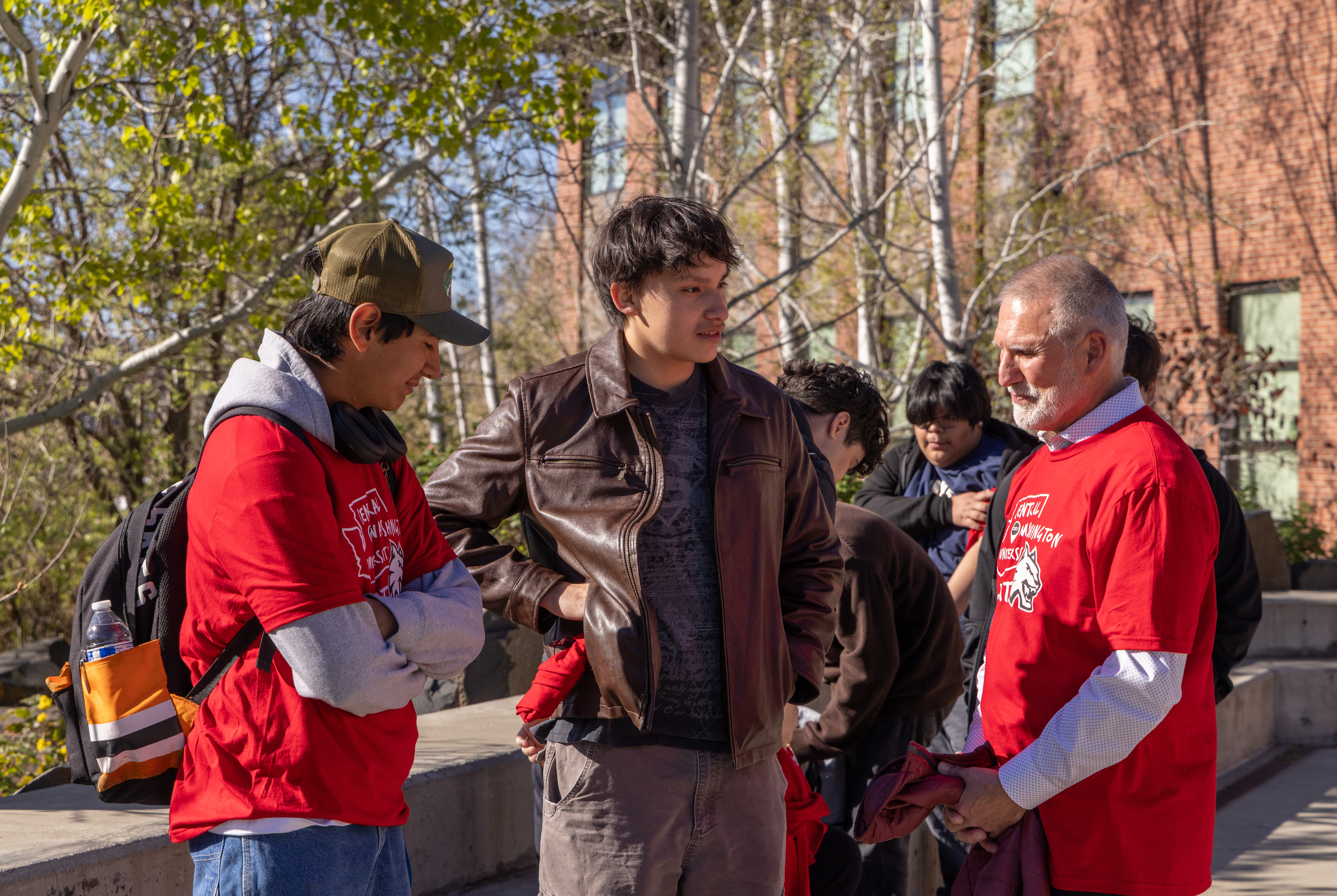 A photo of CWU President Wohlpart with two students from Yakima Schooll District