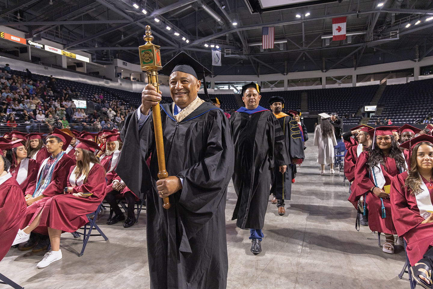 Andy Parks carries the mace at the 2023 commencement ceremony in Kent