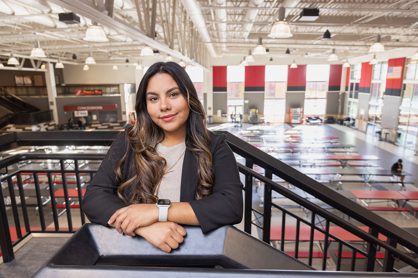 Angela Gonzalez stands in the commons at East Valley High School, where she now works