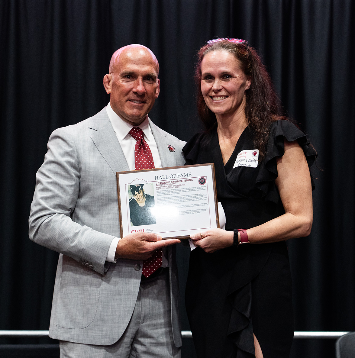 Carianne Davis Ferencik accepts her award from Athletic Director Dennis Francois