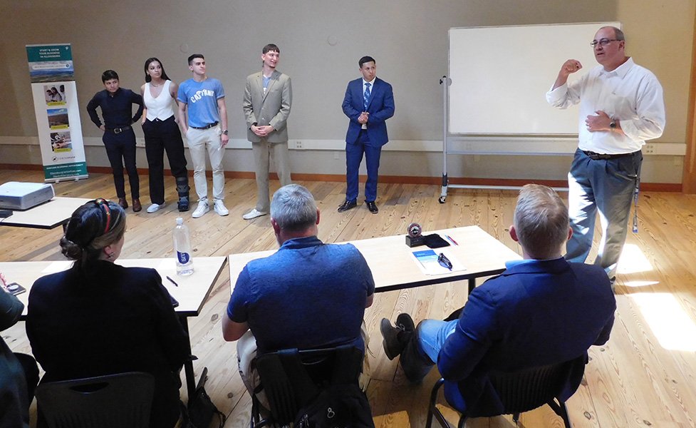 CWU Business instructor Rob Ogburn talks to the judge panel at Cat Tank.