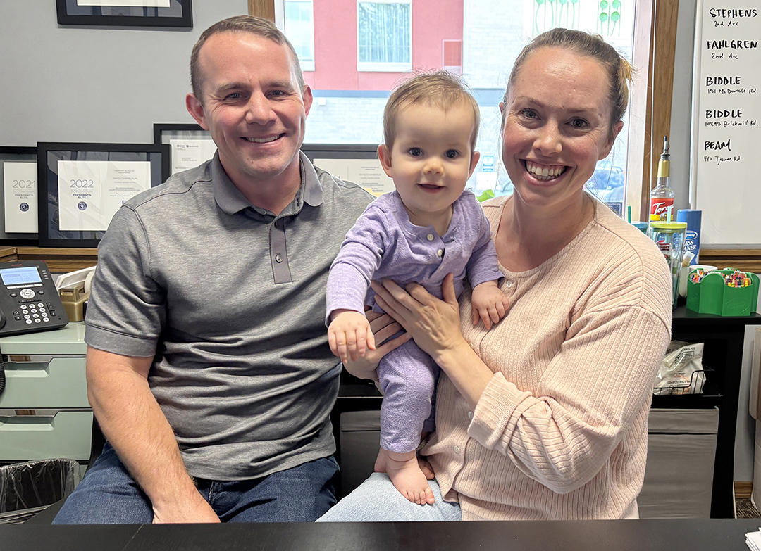 David and Erin Chamberlin sit in their downtown office with their daughter, Lydia.