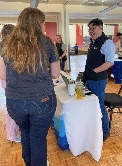 Students talk to one of the booth representatives at the April 27 event