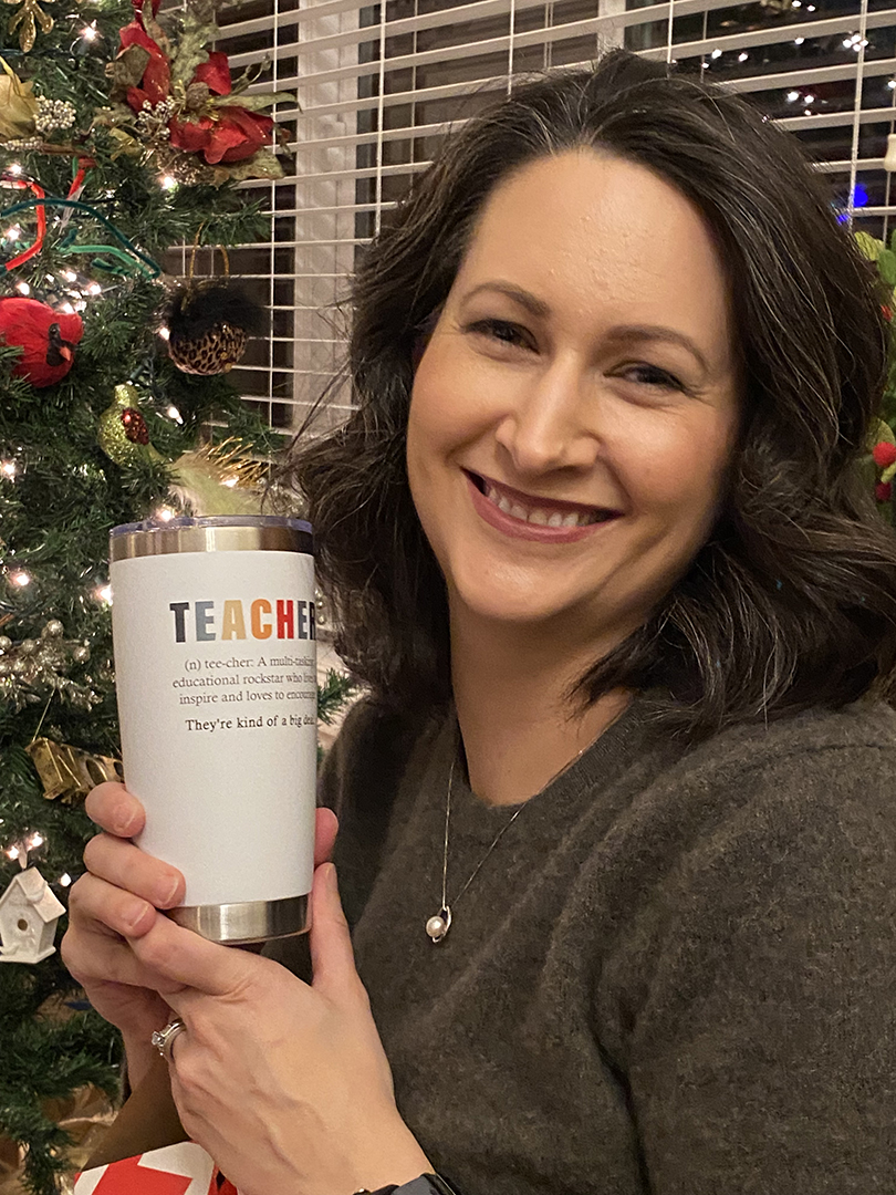 Christine Deacon holds up a teacher mug she got for Christmas