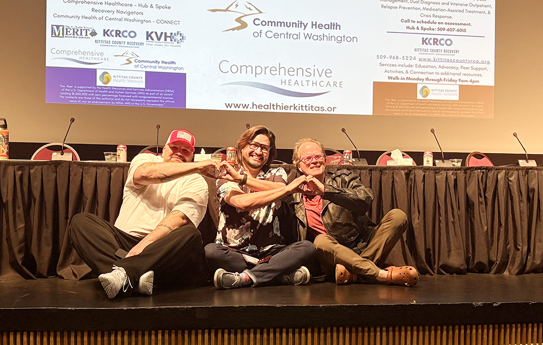 Three CWU employees on stage in support of the Collegiate Recovery Center