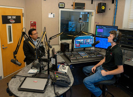 Commerce Director Mike Fong meets with a CWU student on the radio