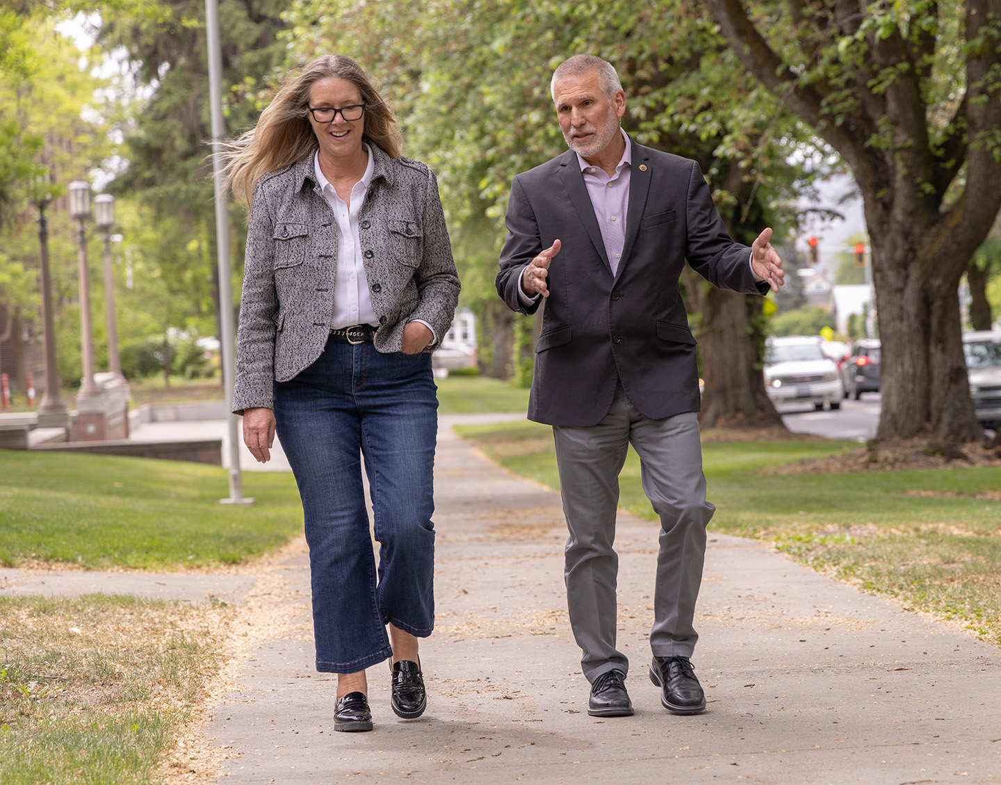 CWU President Jim Wohlpart and Comprehensive CEO Jodi Daly walk on campus.