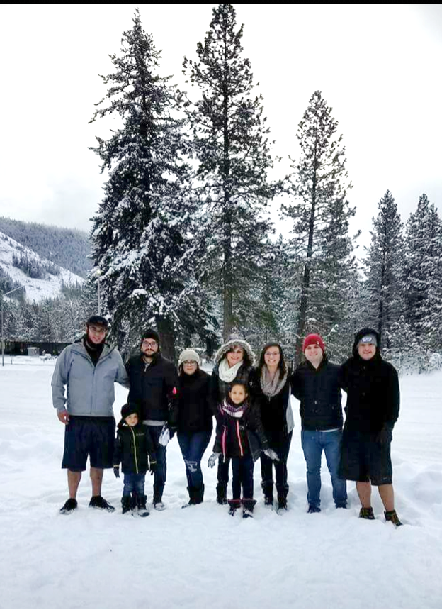 Conchita Chinchilla and her family in the snow with trees behind