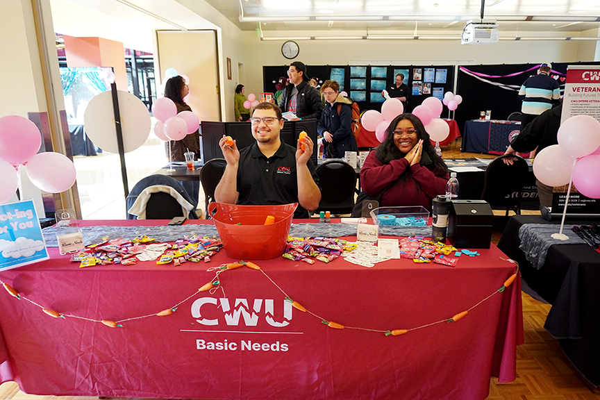 Two CWU representatives at a booth during Coping With Clouds event