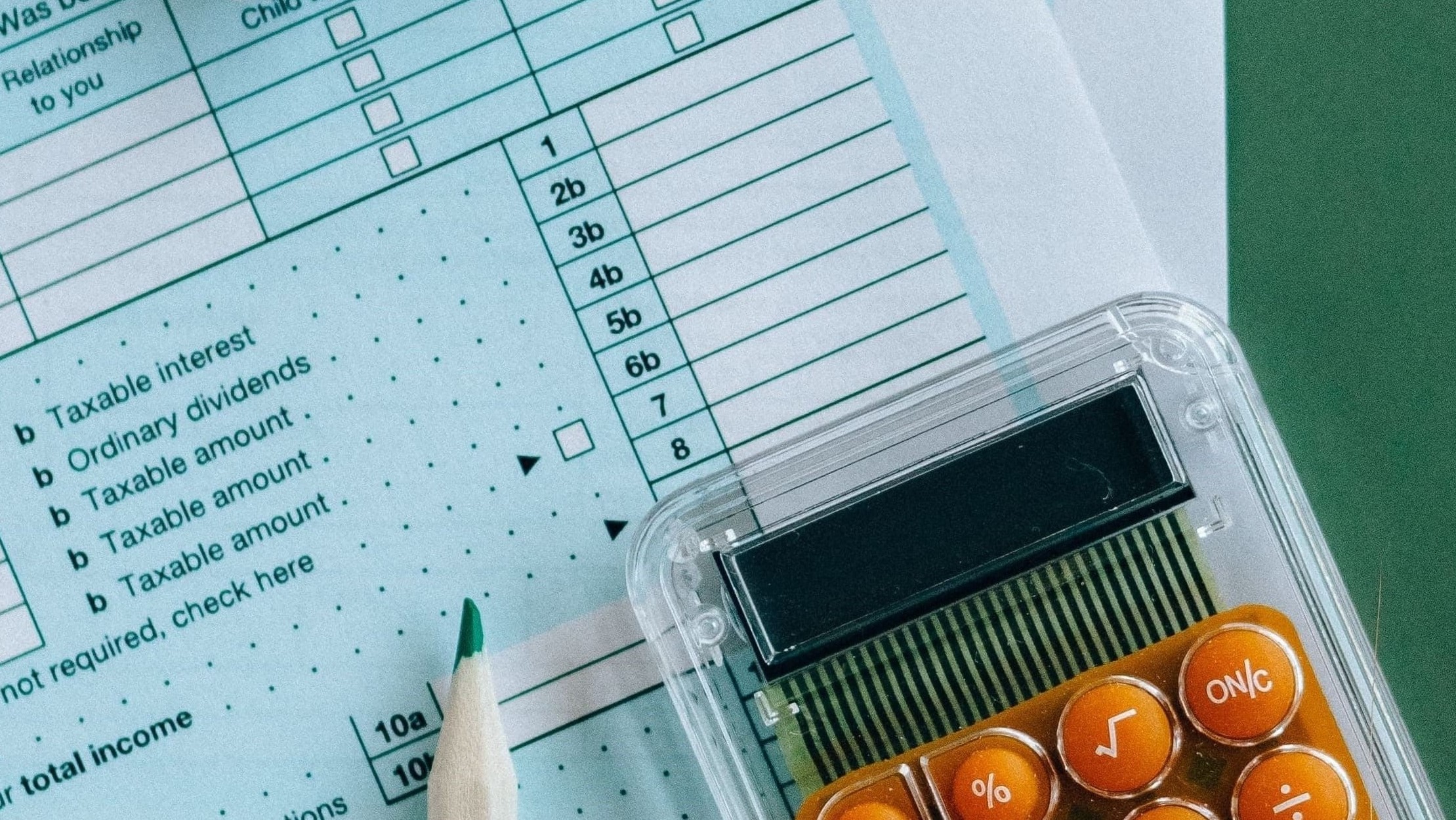 A calculator and pencil on a tax form, to illustrate accounting