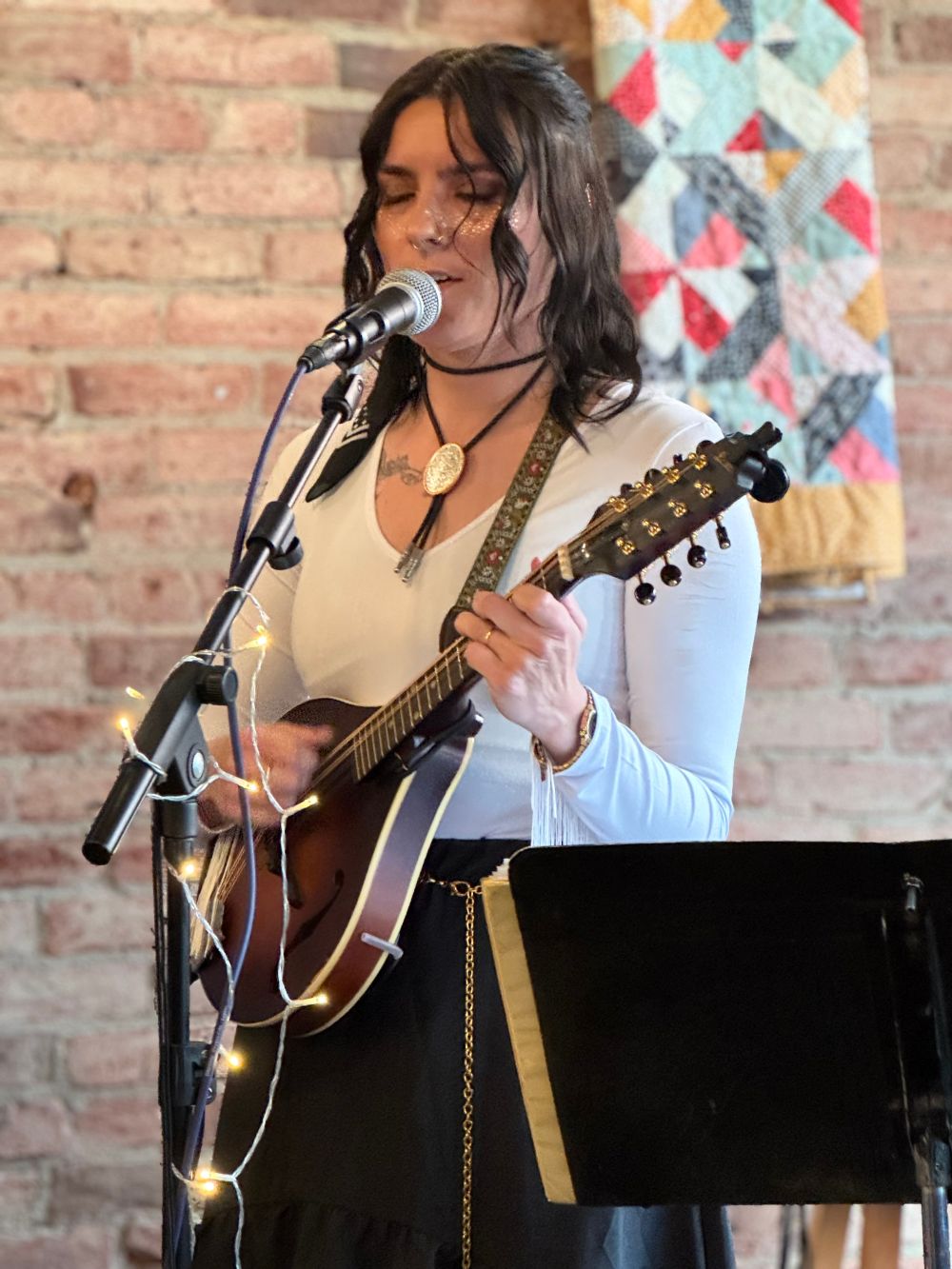 Ash Perron performing with a mandolin.