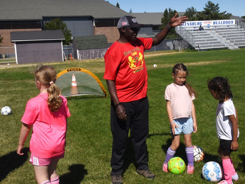 Blaise Dondji gives instruction to young soccer players at Bawa Soccer Camp