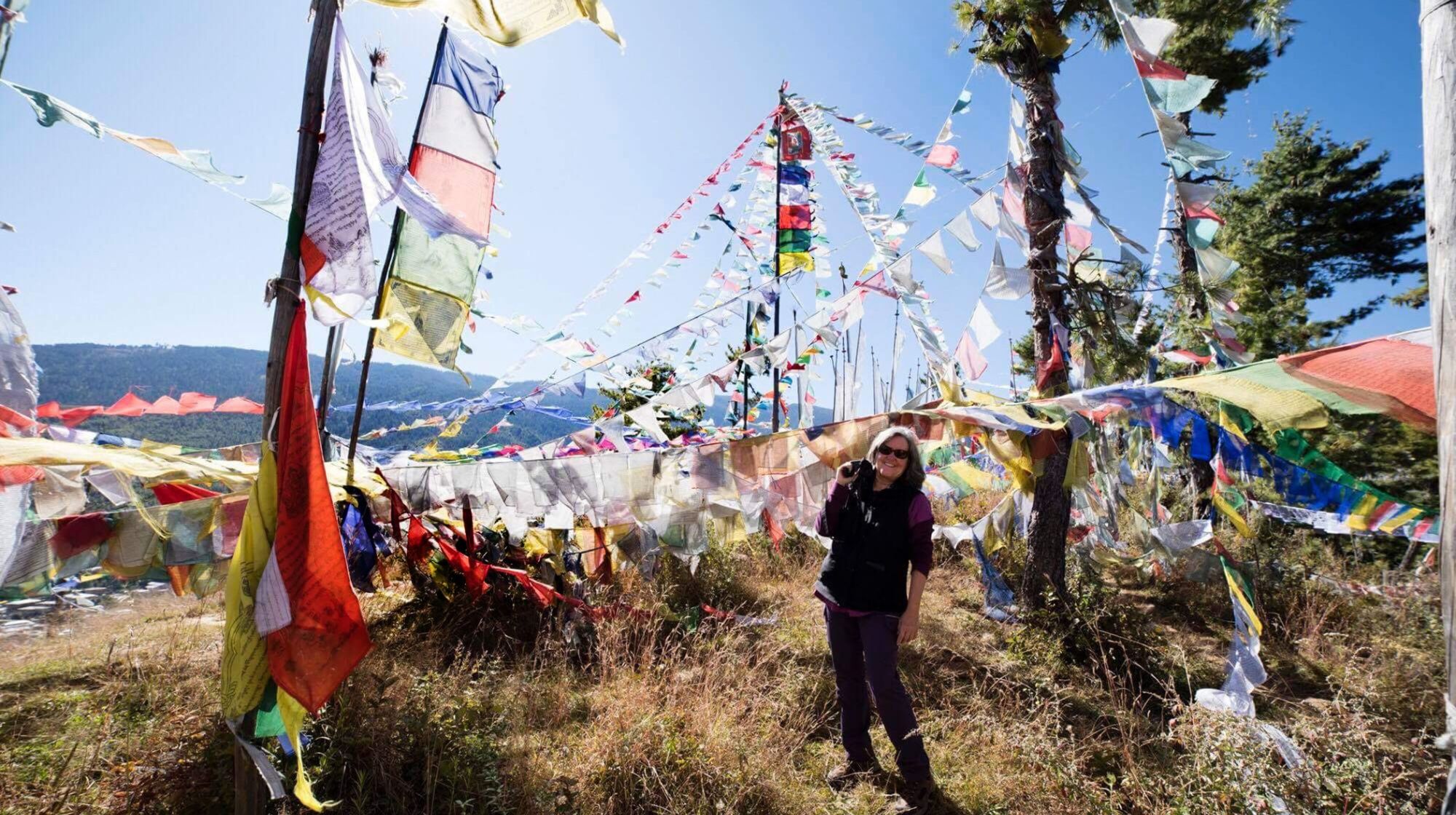 Kiefer at Sangaygang surrounded by Bhutanese prayer flags.