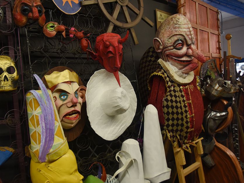 Masks and props are displayed on a rack