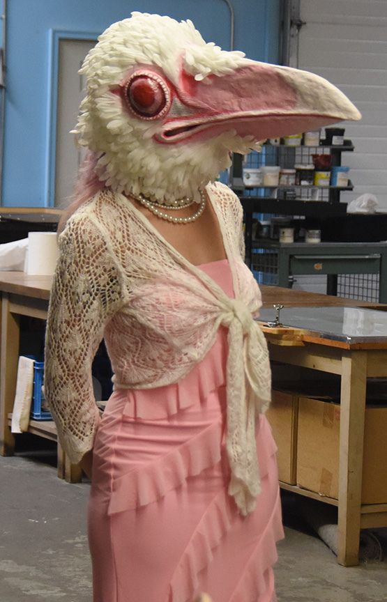 A female patron of Blue Bear poses with the mask she made.