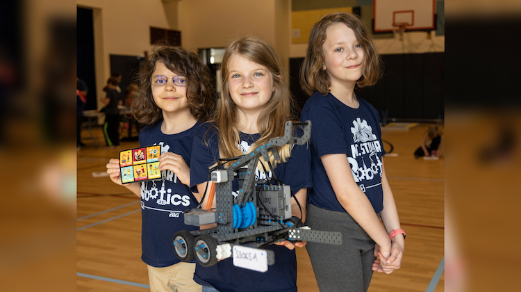 L-R: Emery Klyve, Aspen Moore, and Maddy Bryant, holding their robot, Bolt