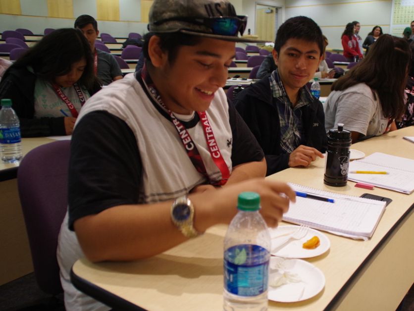 Dare to Dream students eat a snack and converse in a classroom