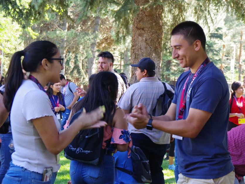 Student mentors playing rock-paper-scissors on a sunny day