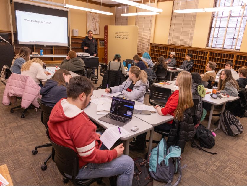 DHC students discussing important stuff in a classroom