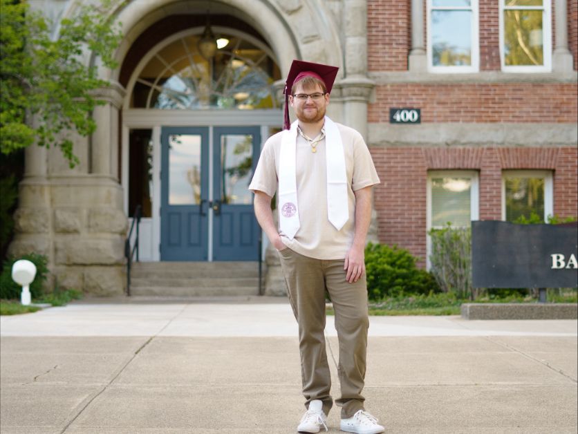 Grad photo of Dylan Zintz taken in front of Barge Hall