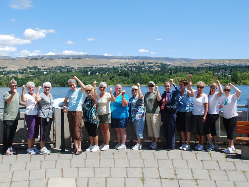 An EASE Cancer class looks proud and strong by the riverside.