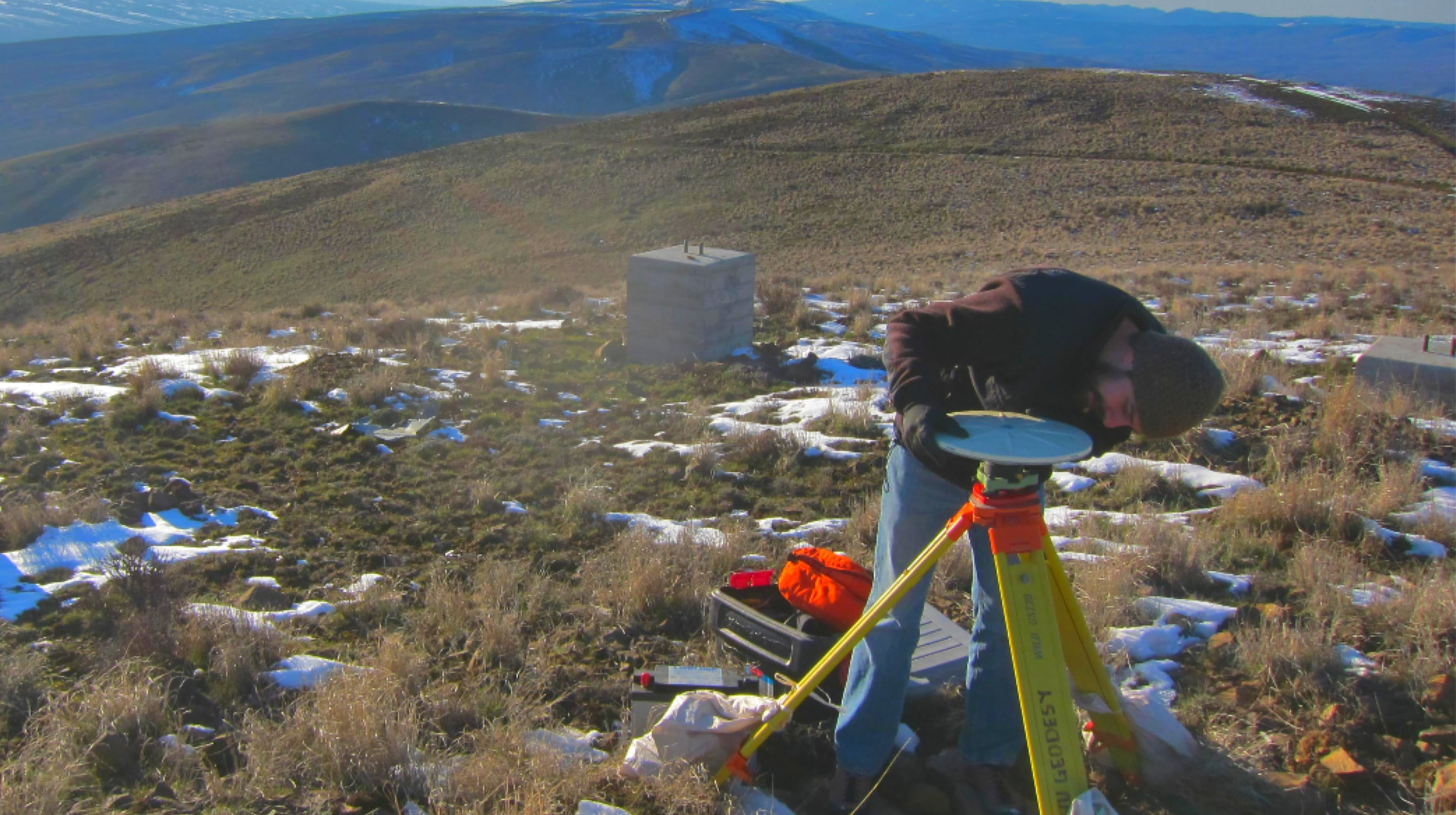 Associate Professor of Geology Walter Szeliga inspects a geodesic research station.