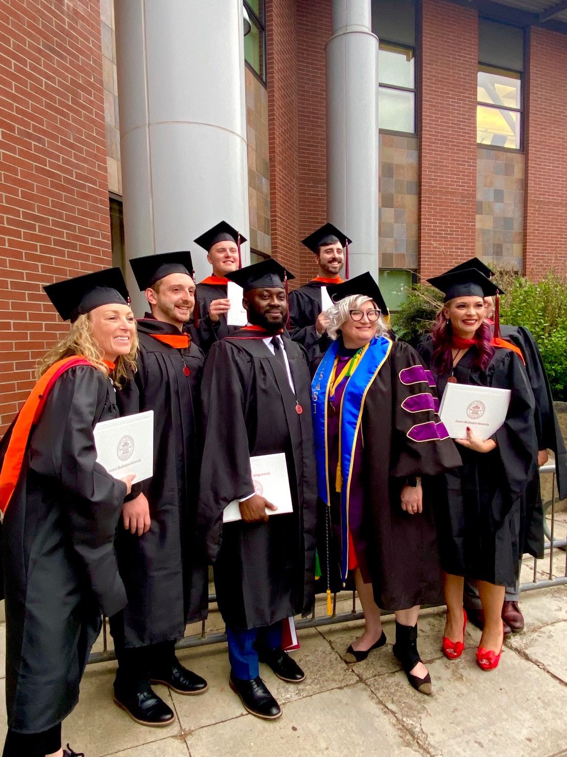 Jennifer Serne with a group of CWU faculty members in their regalia.