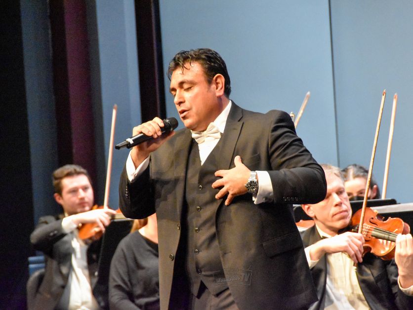 Jose Iniguez belts out a tune backed by an orchestra