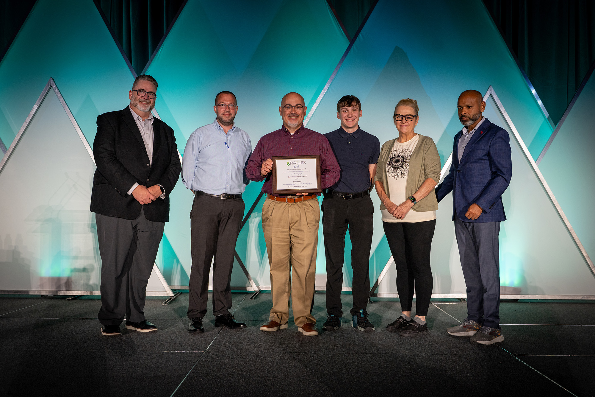 Photo of the CWU Dining team at the NACUFS conference, receiving their award.