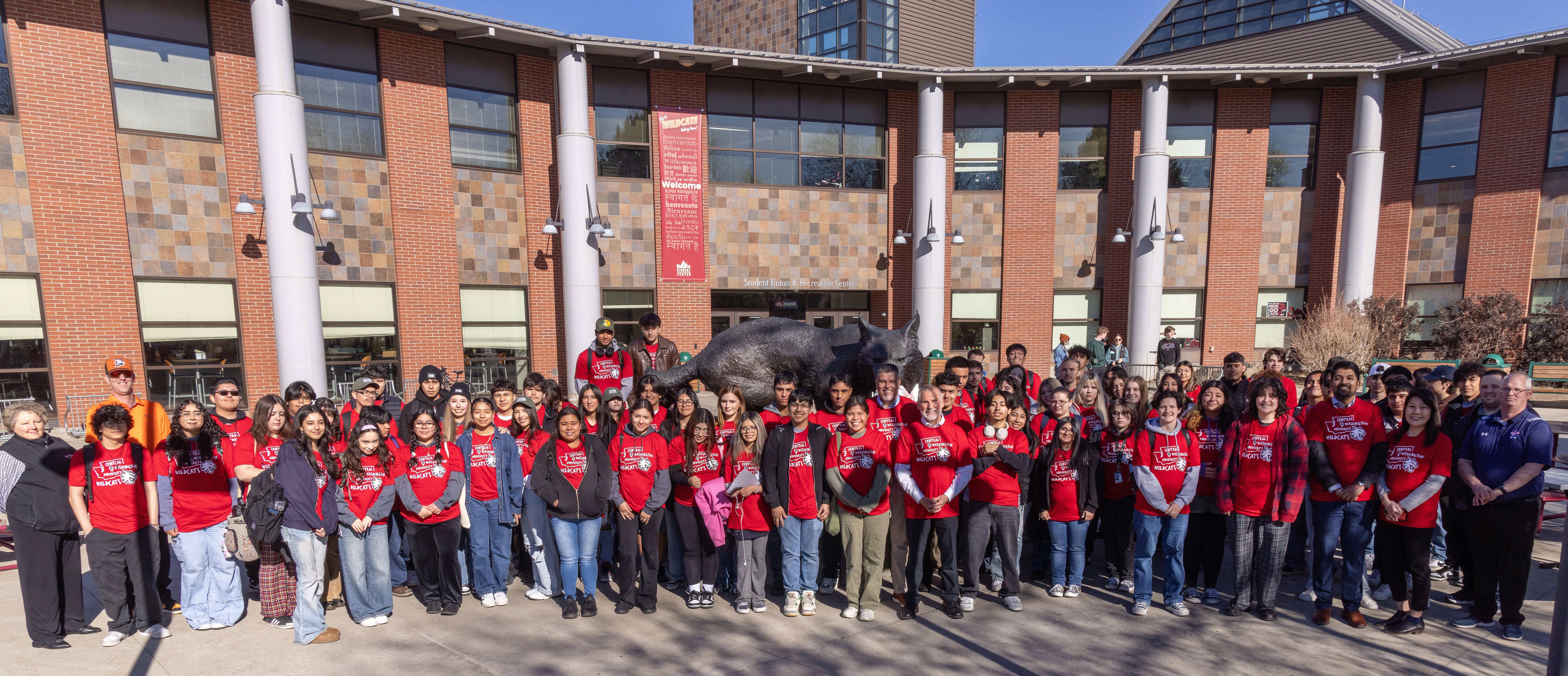 High school students take a group photo in front of the SURC