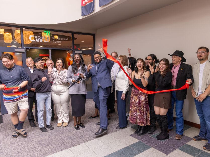 Stakeholders and leadership cheer as the ribbon is cut in front of the brand-new Multicultural Center